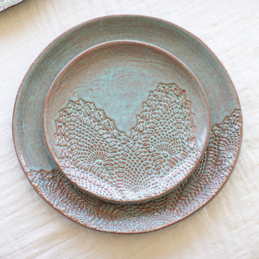 Set of ceramic plates with textured design on a light background