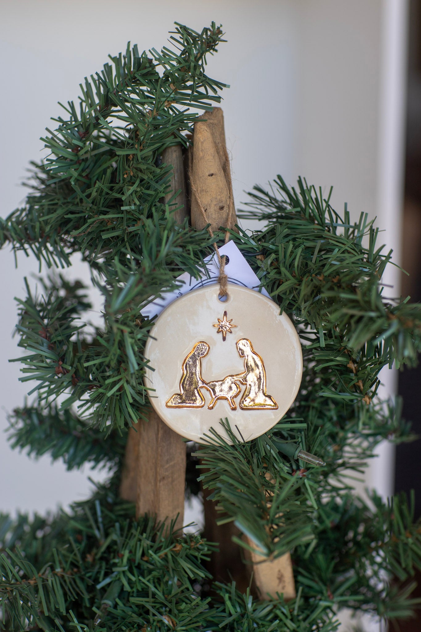 Decorative ornament with nativity scene on a Christmas tree